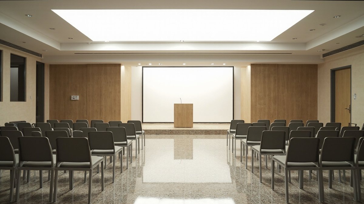 Empty rows of chairs in a strata AGM hall after quorum failed to gather