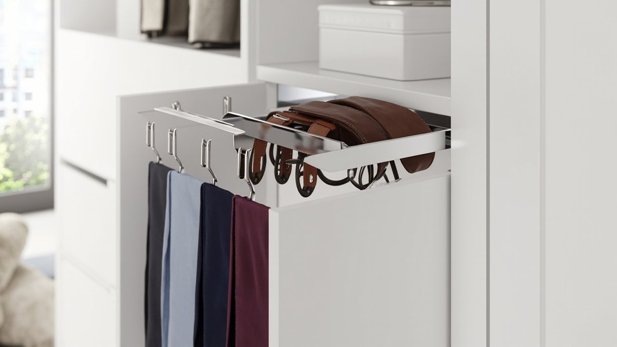 Illustrative concept design: white wardrobe with a chrome pull-out tie and belt rack, plain ties on hooks and coiled leather belts in the tray