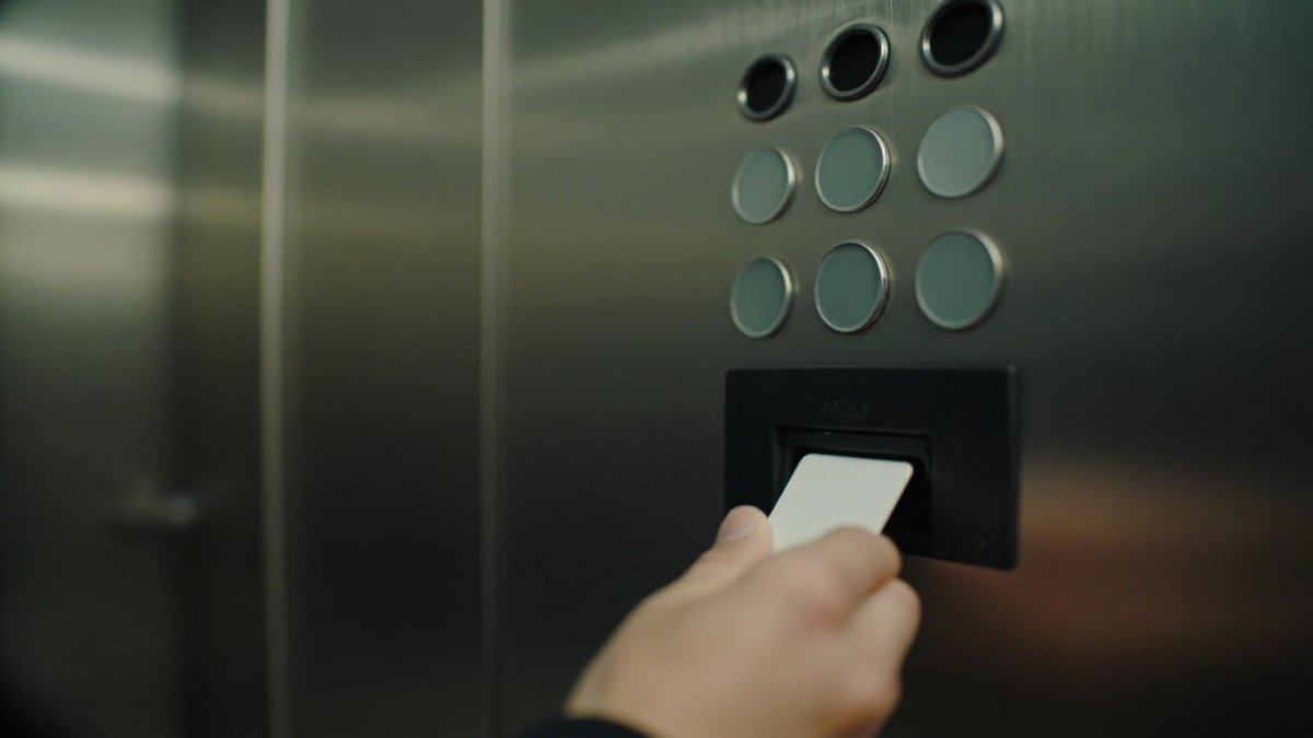 Access card held to a reader beside the floor buttons inside a condo lift
