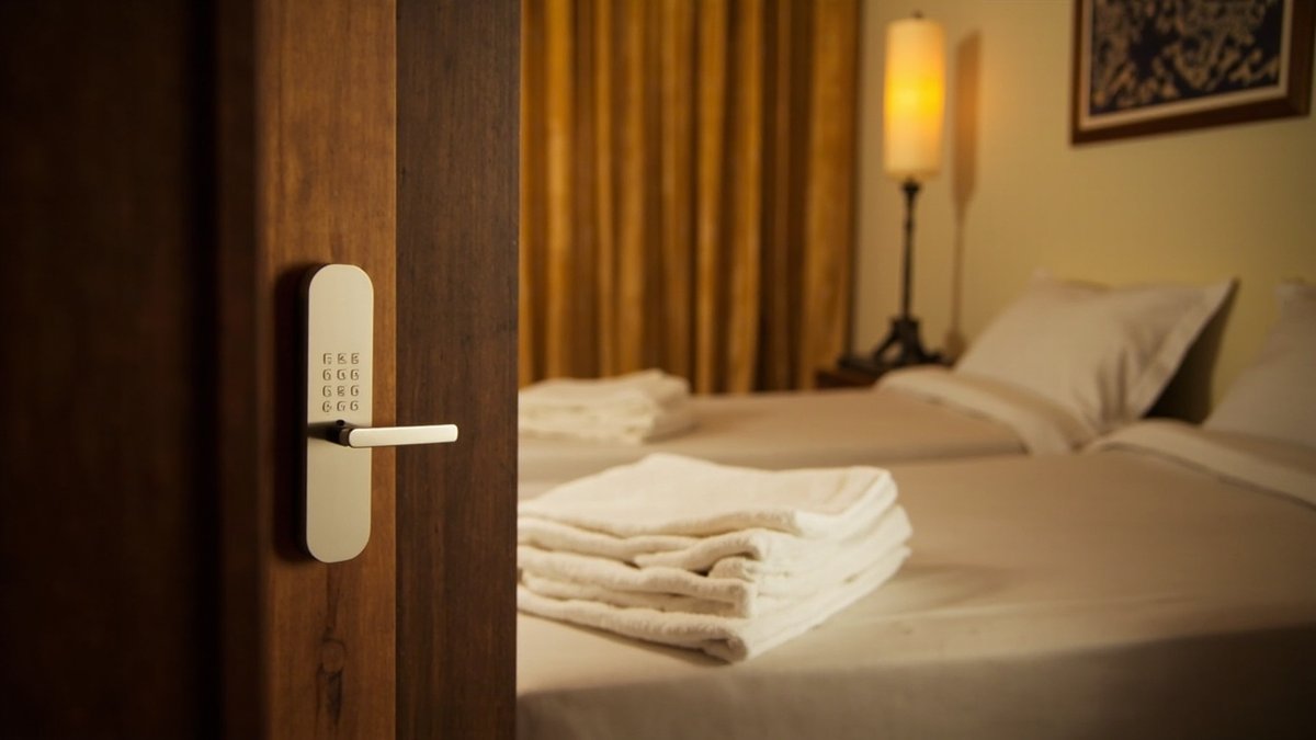 Guesthouse corridor in a converted terrace house with keypad-locked guest room doors