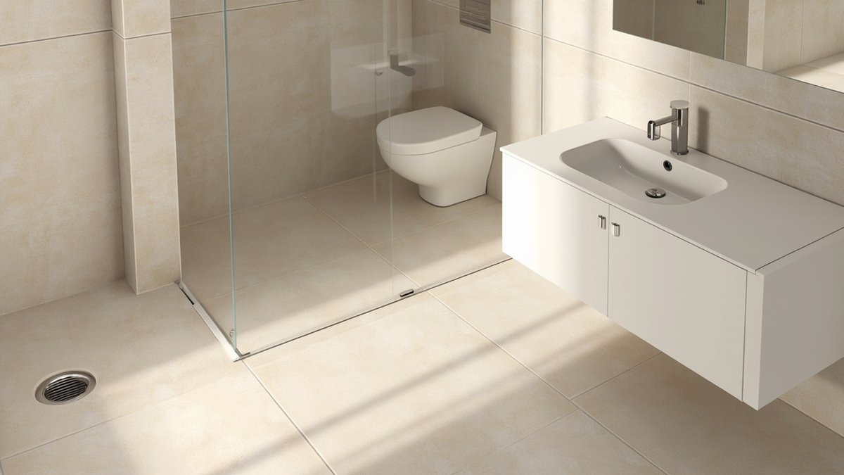 Illustrative concept design: very large light beige stone-look porcelain tiles on floor and walls with a white wall-hung vanity and a frameless glass shower panel