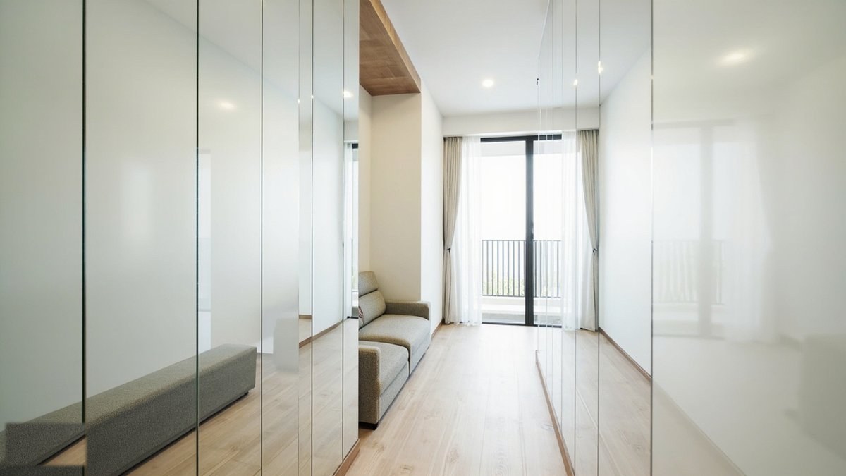 Illustrative concept design: frameless floor-to-ceiling mirror panels along a narrow condo room