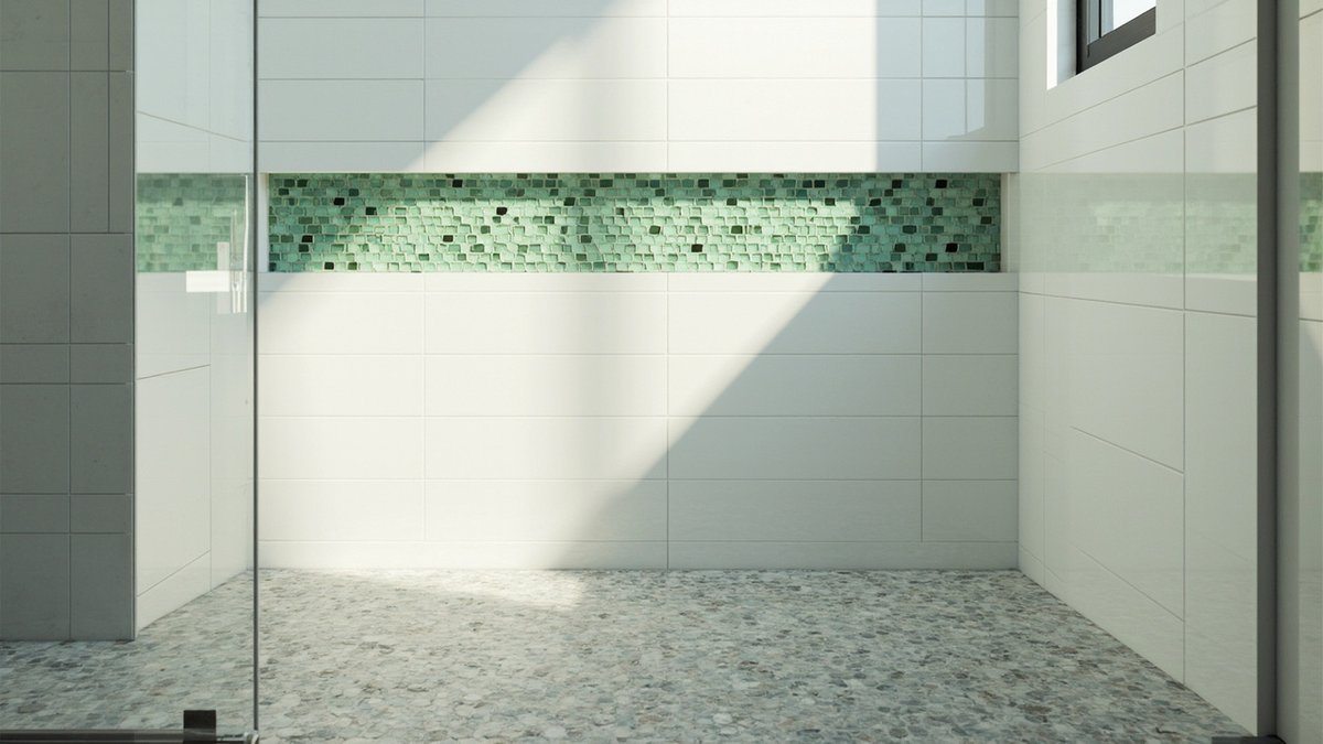 Shower floor in small grey hexagon mosaic with a green glass mosaic strip on a white tiled wall