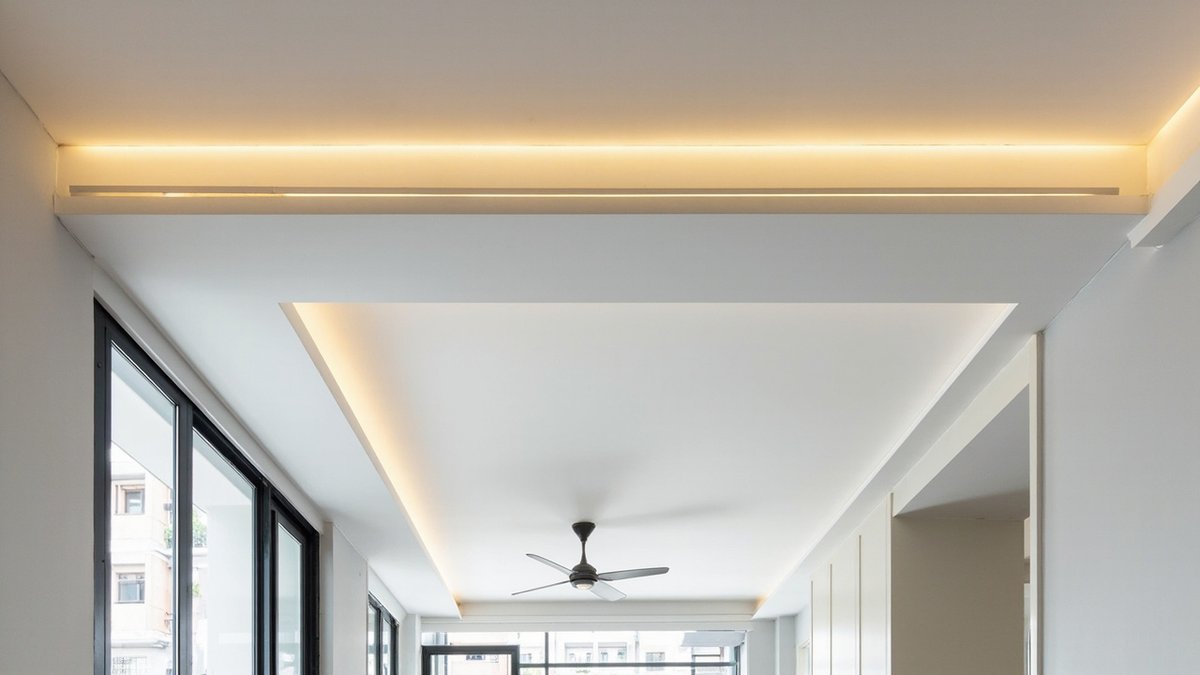 Illustrative concept design: plaster beam box carried wall to wall as one band with a warm linear light slot