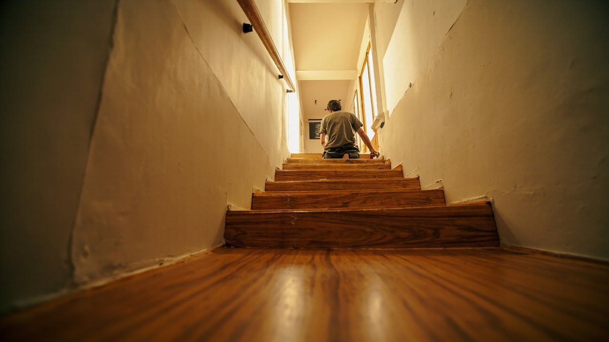 Worker refinishing the staircase of a two-storey terrace house in Setapak