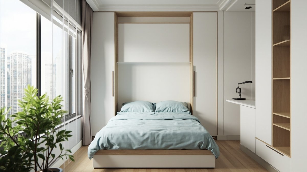 Illustrative concept design: wall bed folded down from its white and pale oak cabinet between tall cabinets, with a slim desk at the side of a small condo room