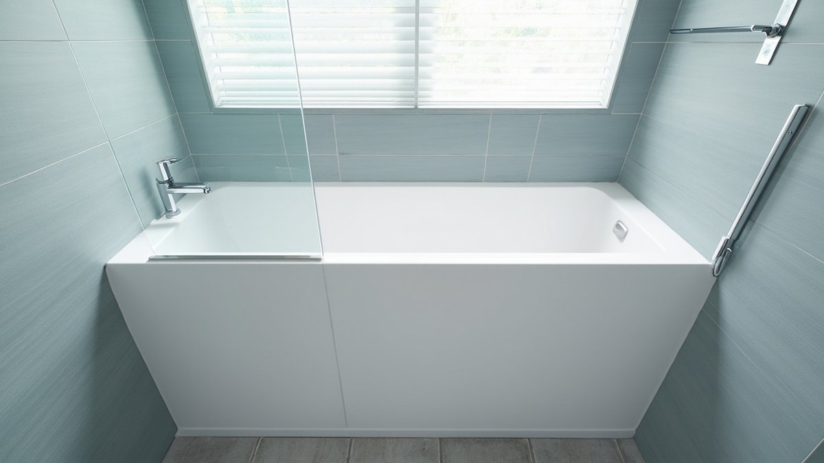 Illustrative concept design: white built-in bathtub with a glass bath screen and hand shower in a pale blue-grey condo bathroom