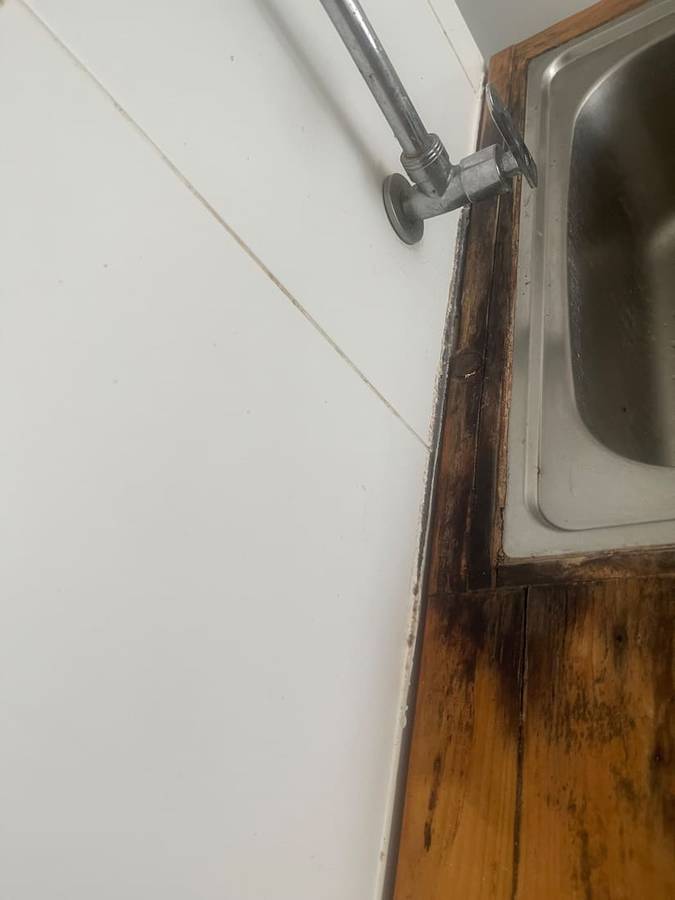 Before: Sink edge stripped & re-sealed